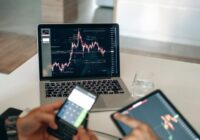 Hands using digital devices for financial analysis at a modern desk setup., tags: di performance - pexel