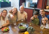 A happy family enjoying a meal together, showcasing togetherness and joy at a dining table., tags: familiari - pexel